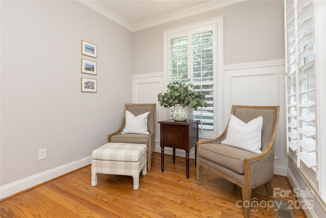 1517 Waverly Ave, Charlotte, NC 28203 - living area featuring ornamental molding, light wood finished floors, a decorative wall, and a wainscoted wall