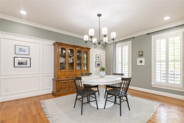 1517 Waverly Ave, Charlotte, NC 28203 - dining area featuring a chandelier, light wood-type flooring, ornamental molding, and baseboards