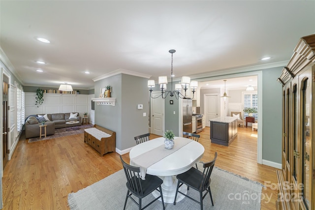 1517 Waverly Ave, Charlotte, NC 28203 - dining space with crown molding, light wood-style floors, baseboards, and recessed lighting