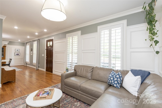1517 Waverly Ave, Charlotte, NC 28203 - living area with crown molding, a decorative wall, wood finished floors, healthy amount of natural light, and recessed lighting