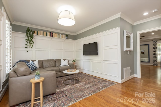1517 Waverly Ave, Charlotte, NC 28203 - living room with a decorative wall, light wood-style flooring, ornamental molding, healthy amount of natural light, and recessed lighting