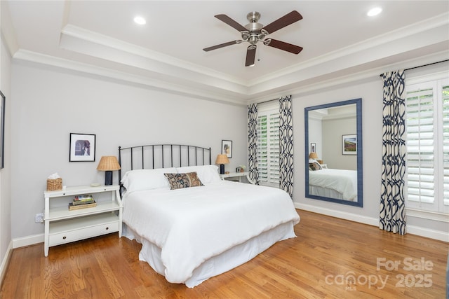1517 Waverly Ave, Charlotte, NC 28203 - bedroom featuring a tray ceiling, crown molding, wood finished floors, baseboards, and recessed lighting