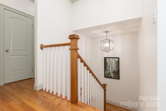 1517 Waverly Ave, Charlotte, NC 28203 - stairway with wood finished floors, a chandelier, and baseboards