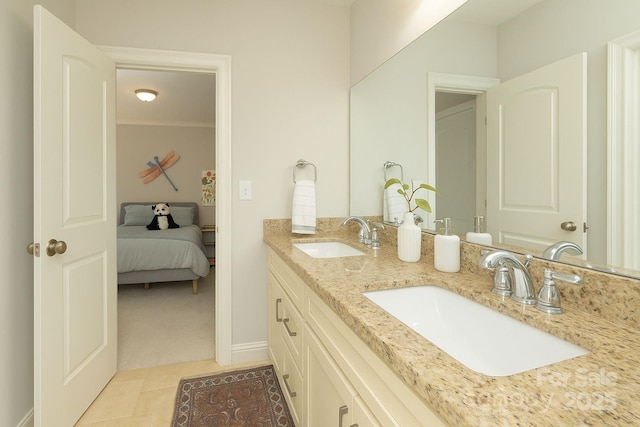 1517 Waverly Ave, Charlotte, NC 28203 - ensuite bathroom with double vanity, baseboards, tile patterned floors, and crown molding