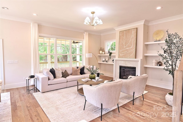116 S Broad St, Waxhaw, NC 28173 - living area with crown molding, a premium fireplace, a chandelier, recessed lighting, and wood finished floors