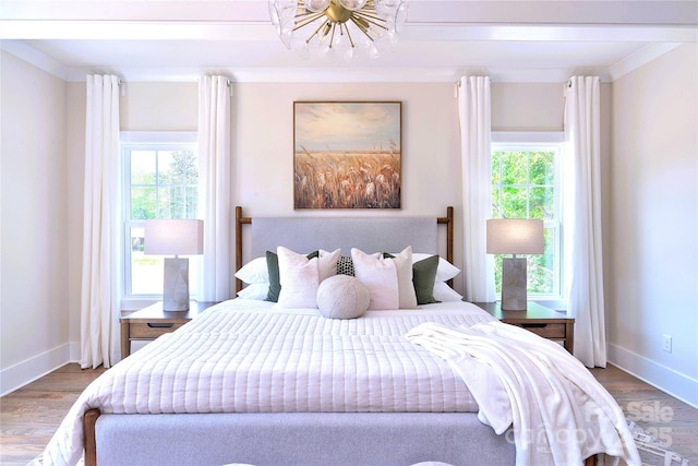 116 S Broad St, Waxhaw, NC 28173 - bedroom with baseboards, wood finished floors, and a chandelier