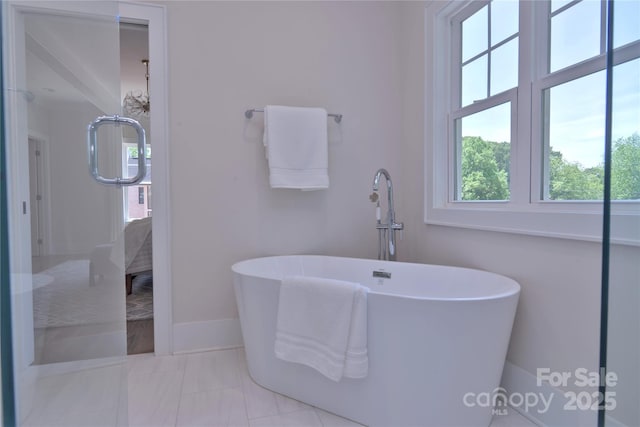 116 S Broad St, Waxhaw, NC 28173 - bathroom with baseboards, marble finish floor, and a soaking tub
