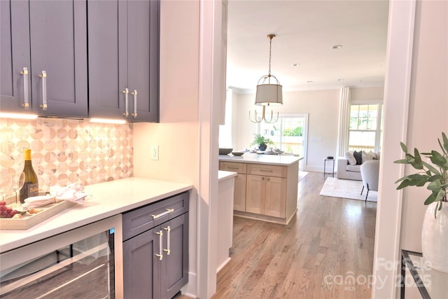 116 S Broad St, Waxhaw, NC 28173 - kitchen with light wood-style floors, tasteful backsplash, light countertops, open floor plan, and wine cooler