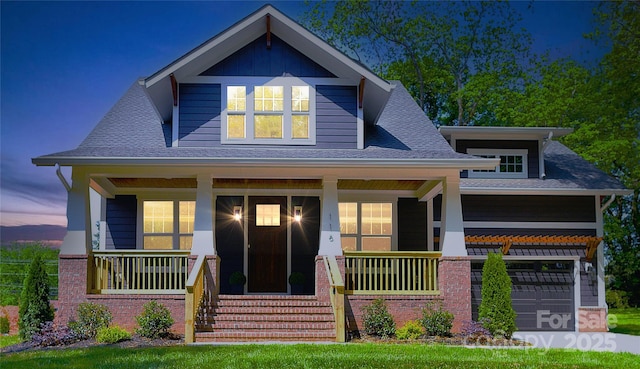 116 S Broad St, Waxhaw, NC 28173 - view of front of house with brick siding, a garage, roof with shingles, and covered porch