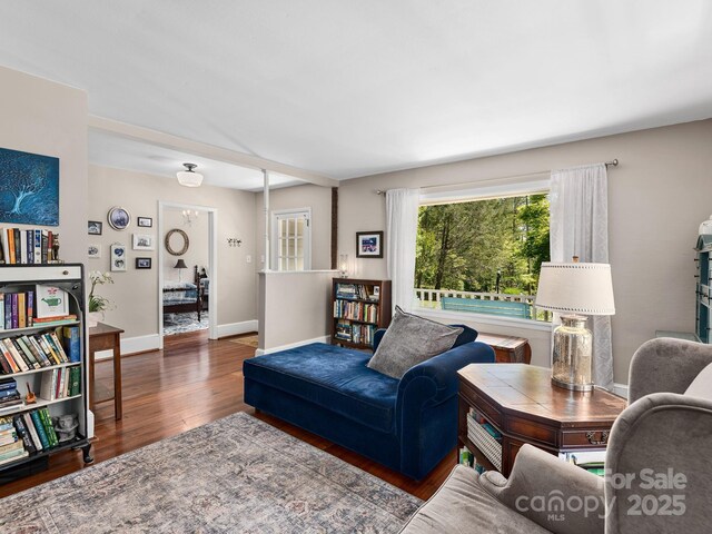 living area featuring baseboards and wood finished floors