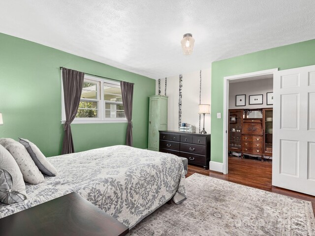bedroom featuring a textured ceiling and wood finished floors