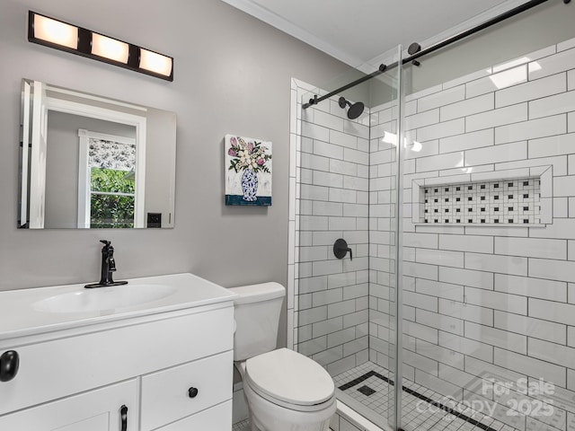 bathroom featuring vanity, toilet, ornamental molding, and a stall shower