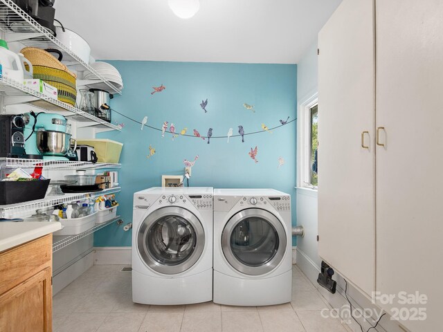 washroom featuring light tile patterned floors, baseboards, laundry area, and independent washer and dryer