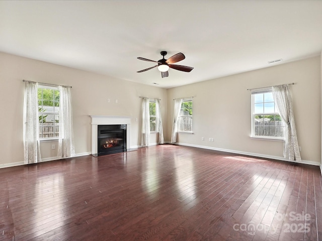 5355 Hackberry Ln SW, Concord, NC 28027 - unfurnished living room with a glass covered fireplace, plenty of natural light, hardwood / wood-style floors, and visible vents