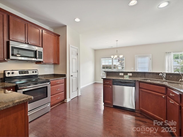 5355 Hackberry Ln SW, Concord, NC 28027 - kitchen with a sink, a chandelier, stainless steel appliances, recessed lighting, and dark wood-type flooring