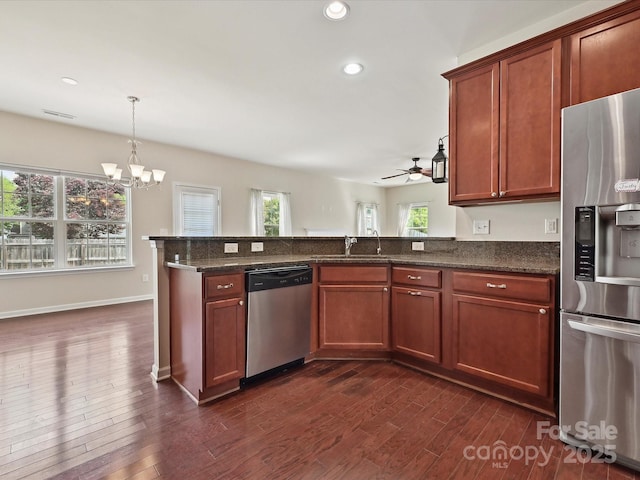5355 Hackberry Ln SW, Concord, NC 28027 - kitchen featuring a sink, ceiling fan with notable chandelier, stainless steel appliances, recessed lighting, and dark wood-type flooring