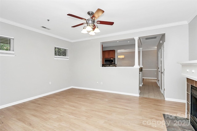 526 N Davidson St, Charlotte, NC 28202 - unfurnished living room with a fireplace with flush hearth, light wood-style floors, crown molding, and a ceiling fan