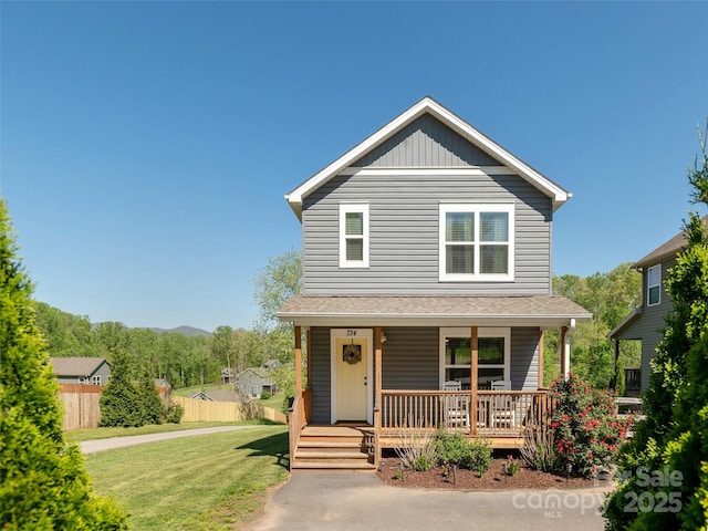 734 Enka Lake Rd, Candler, NC 28715 - traditional-style home with covered porch, fence, and a front lawn