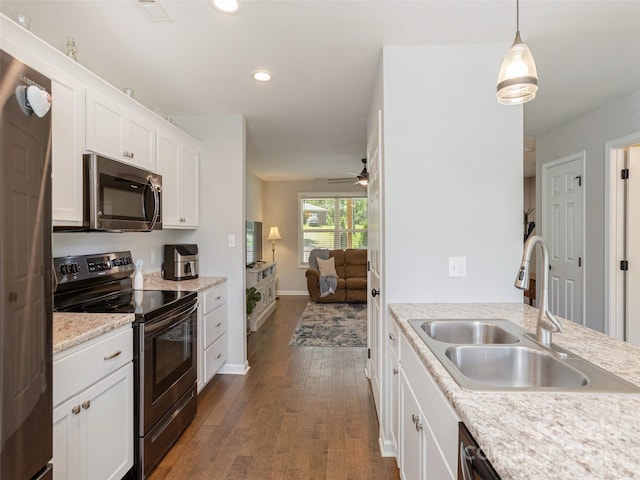 734 Enka Lake Rd, Candler, NC 28715 - kitchen featuring dark wood-style flooring, a sink, stainless steel appliances, recessed lighting, and white cabinetry