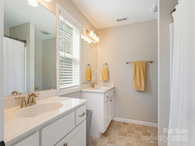 734 Enka Lake Rd, Candler, NC 28715 - bathroom with a sink, baseboards, two vanities, and visible vents