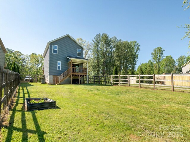 734 Enka Lake Rd, Candler, NC 28715 - view of yard featuring a fenced backyard, stairs, a vegetable garden, and a wooden deck