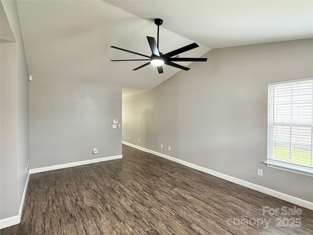 unfurnished room with ceiling fan, vaulted ceiling, dark wood-style flooring, and baseboards