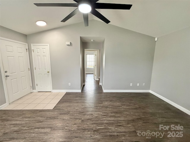 empty room with wood finished floors, baseboards, and a ceiling fan