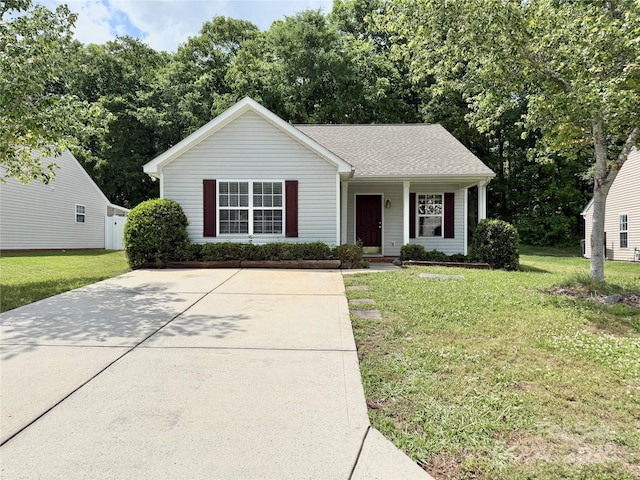 view of front of home featuring a front lawn, a porch, roof with shingles, and concrete driveway