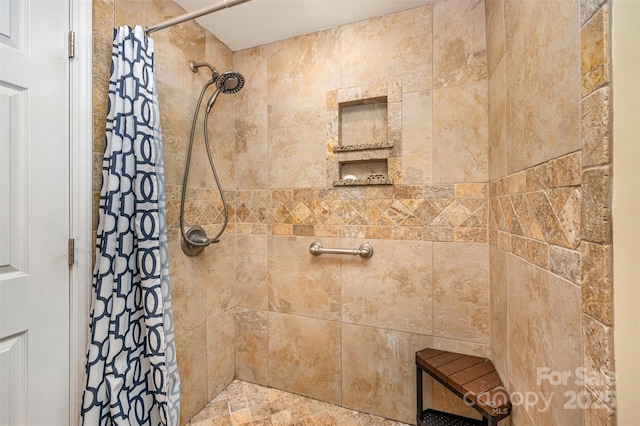 full bath featuring tiled shower