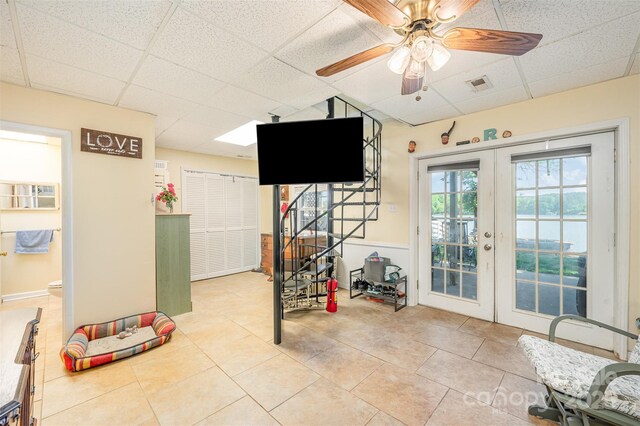 playroom with ceiling fan, visible vents, a paneled ceiling, and tile patterned flooring