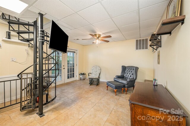 sitting room featuring visible vents, a paneled ceiling, ceiling fan, and light tile patterned floors