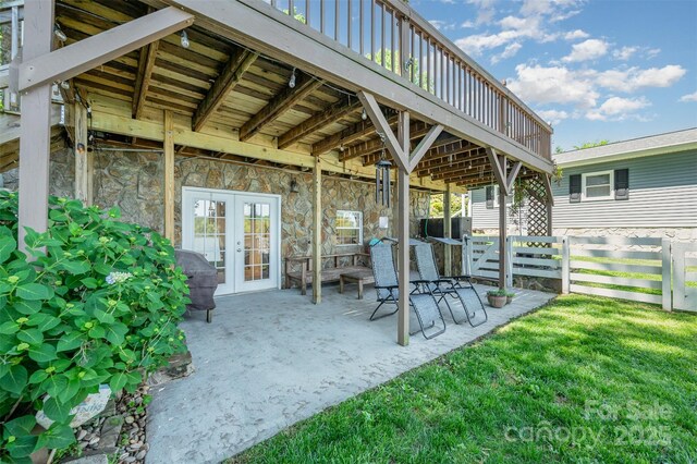 view of patio / terrace featuring fence and french doors