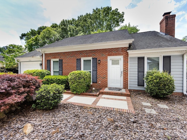 2502 Breuster Dr, Charlotte, NC 28210 - view of front facade with brick siding, an attached garage, a chimney, and a shingled roof