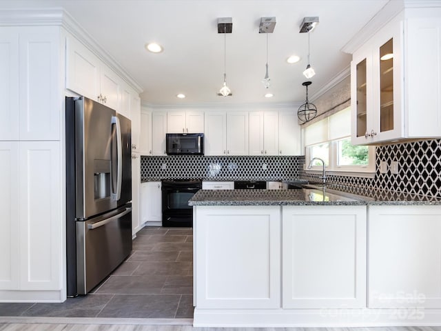 2502 Breuster Dr, Charlotte, NC 28210 - kitchen featuring black microwave, stove, stainless steel fridge, white cabinetry, and a sink