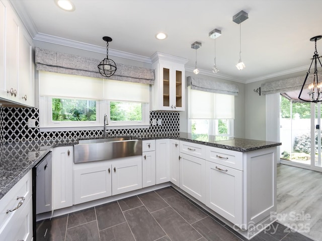 2502 Breuster Dr, Charlotte, NC 28210 - kitchen with a peninsula, glass insert cabinets, white cabinets, a sink, and dishwasher