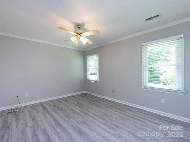 2502 Breuster Dr, Charlotte, NC 28210 - unfurnished room featuring ceiling fan, visible vents, ornamental molding, and wood finished floors