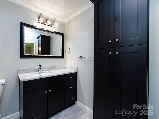 2502 Breuster Dr, Charlotte, NC 28210 - bathroom with wood finished floors, baseboards, vanity, toilet, and ornamental molding