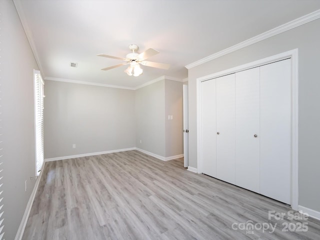 2502 Breuster Dr, Charlotte, NC 28210 - unfurnished bedroom with a closet, baseboards, ornamental molding, and light wood-style floors