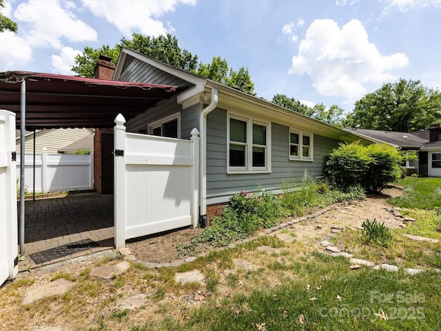 2502 Breuster Dr, Charlotte, NC 28210 - view of home's exterior featuring a gate, fence, and a chimney