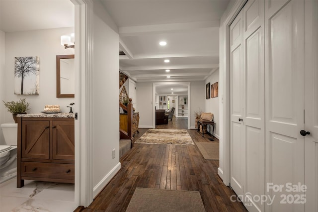 hallway featuring recessed lighting, dark wood finished floors, baseboards, and beamed ceiling