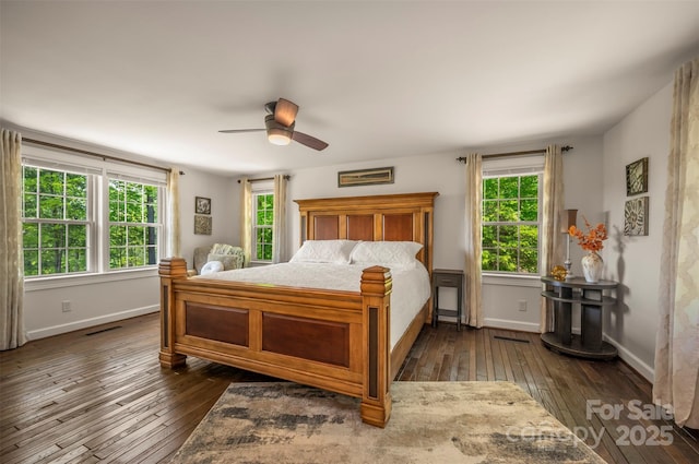 bedroom with baseboards, dark wood finished floors, and ceiling fan