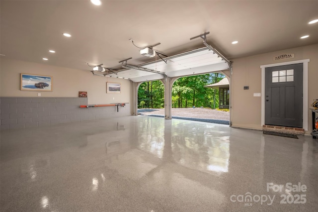 garage featuring recessed lighting and a garage door opener
