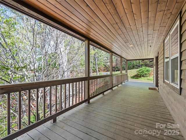wooden terrace featuring covered porch