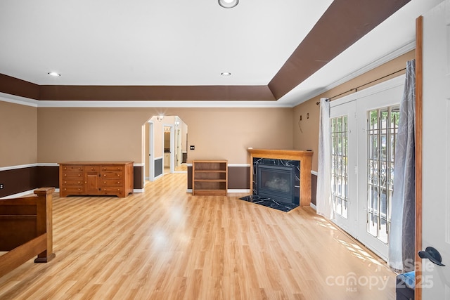 interior space featuring light wood-type flooring, recessed lighting, baseboards, and a premium fireplace