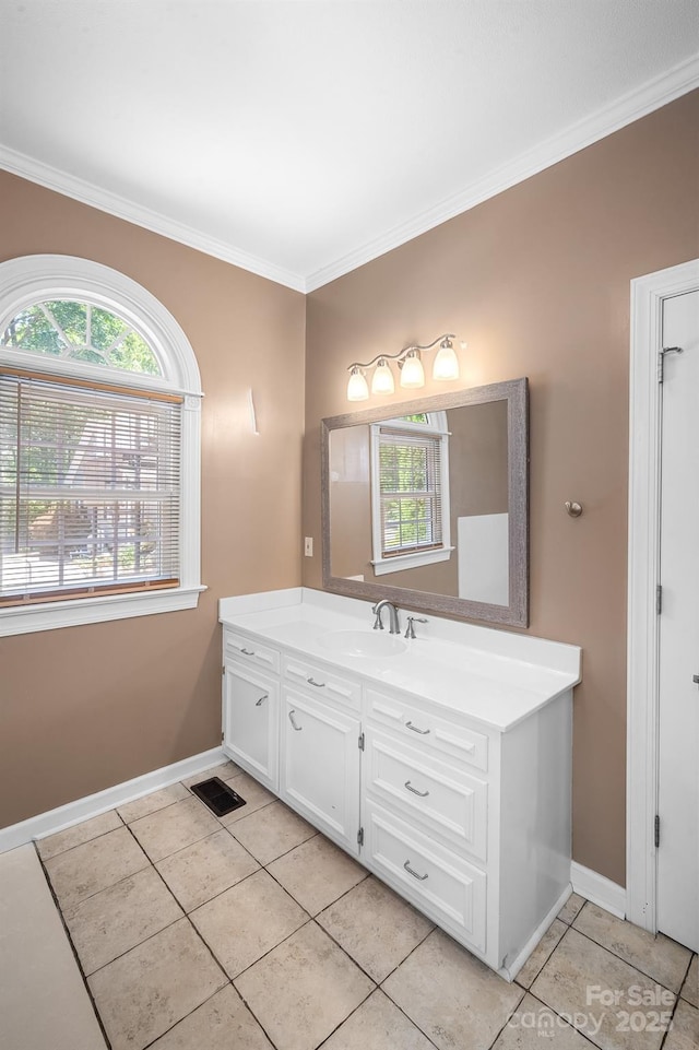 bathroom featuring tile patterned flooring, baseboards, and a wealth of natural light