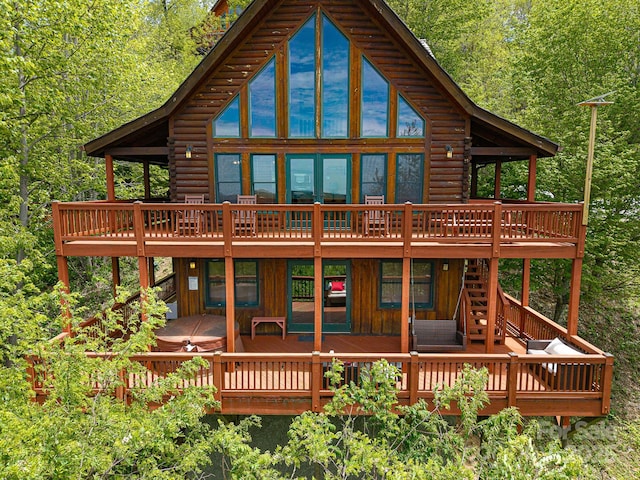 59 Valley Hts, Mars Hill, NC 28754 - back of property featuring a deck, log exterior, a covered hot tub, and board and batten siding