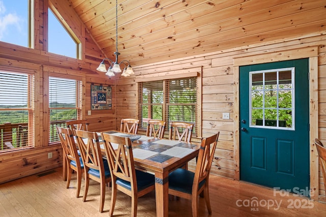 59 Valley Hts, Mars Hill, NC 28754 - dining space with wood walls, a chandelier, light wood-style flooring, healthy amount of natural light, and wood ceiling