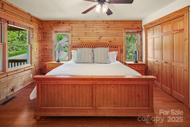 59 Valley Hts, Mars Hill, NC 28754 - bedroom with wood walls, wood finished floors, a closet, and ceiling fan
