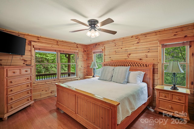 59 Valley Hts, Mars Hill, NC 28754 - bedroom featuring hardwood / wood-style flooring, wood walls, and a ceiling fan