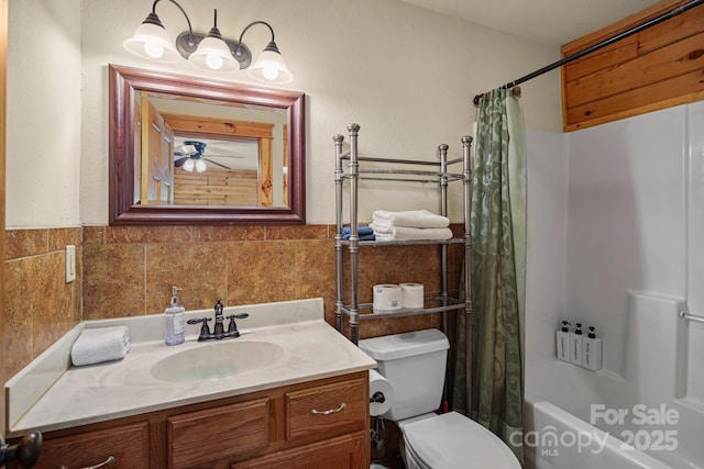 59 Valley Hts, Mars Hill, NC 28754 - bathroom featuring toilet, vanity, tile walls, shower / bathtub combination with curtain, and a wainscoted wall